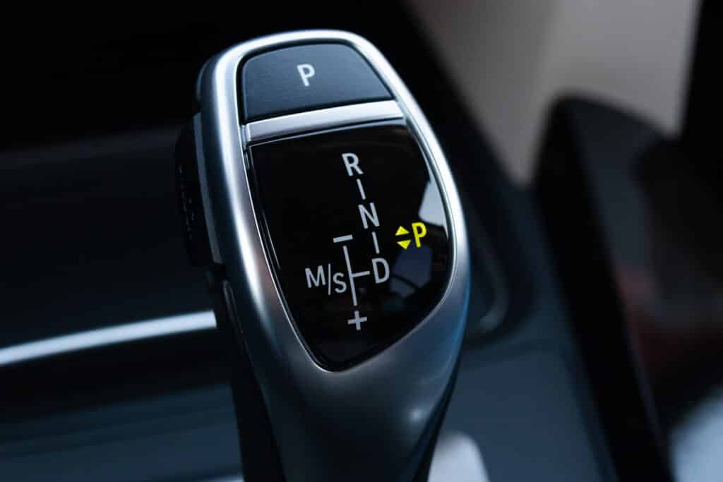 Levier de vitesse automatique voiture : P, R, N, D, M/S Levier de vitesse automatique d'une voiture moderne, affichant les positions P, R, N, D, M/S avec P allumé en jaune.